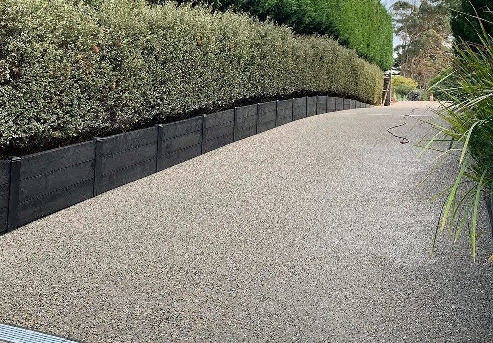 Driveway with an exposed aggregate concrete design.