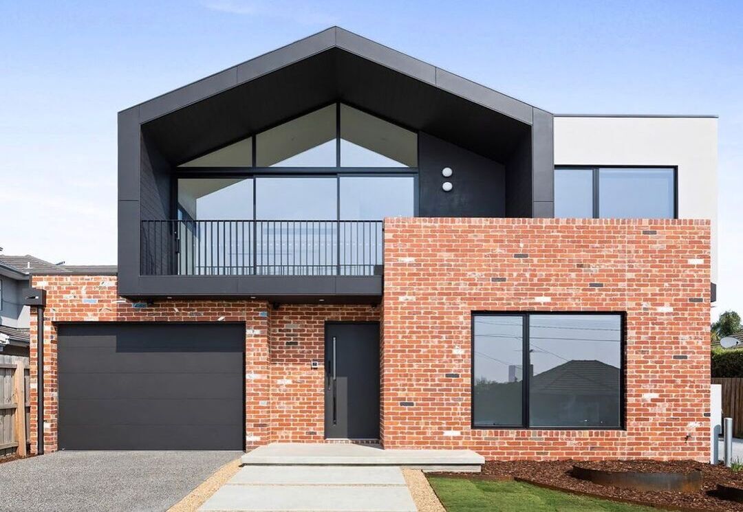 A modern home with a decorative concrete driveway.