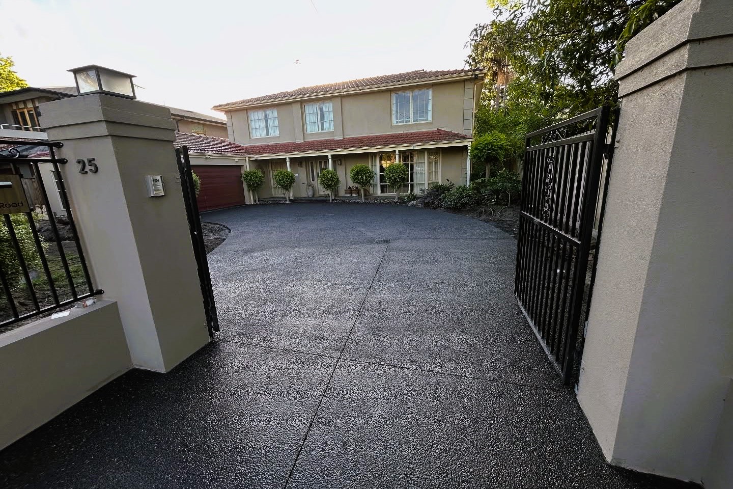 home with black aggregate driveway